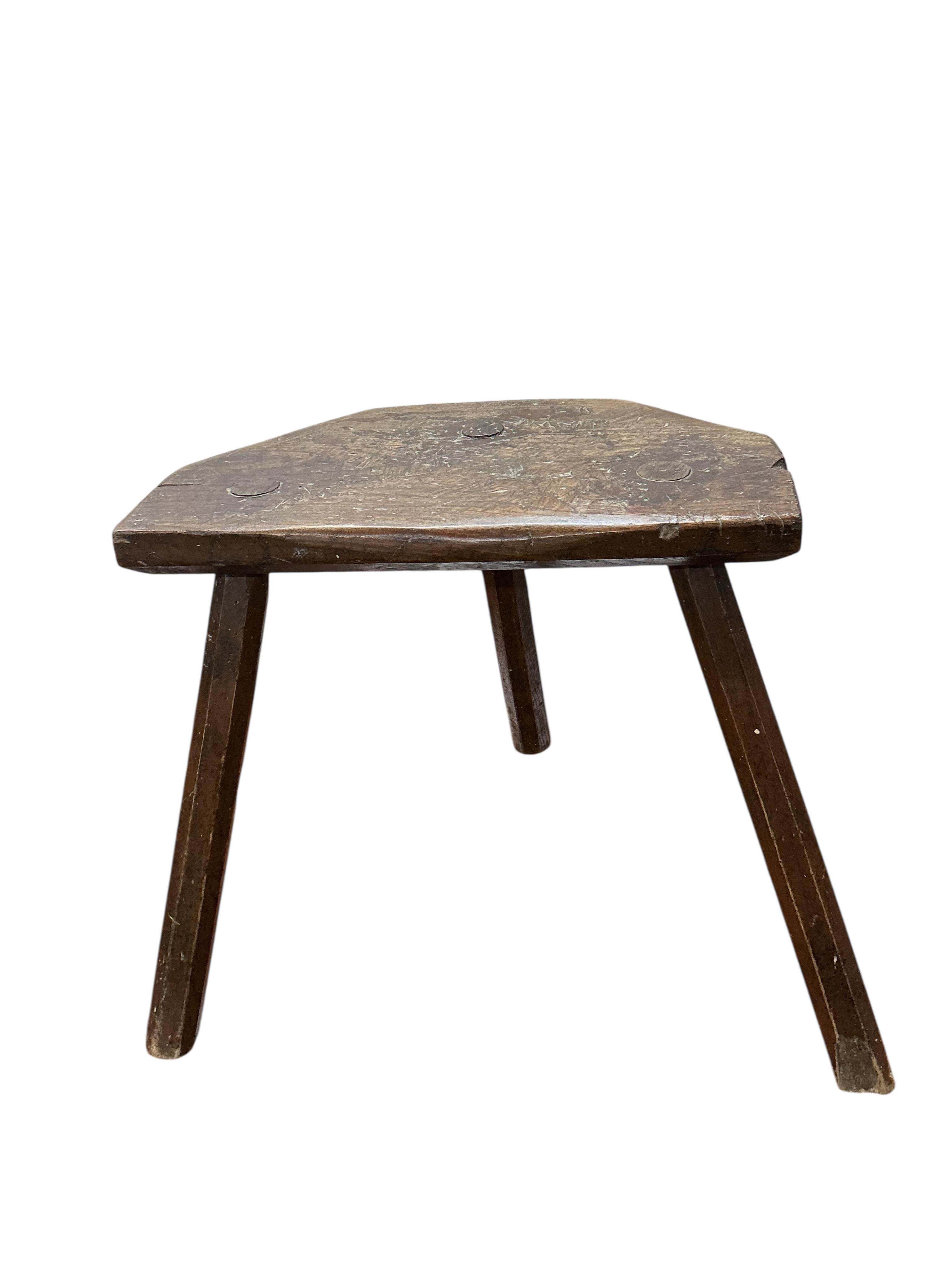A 19th century elm and beech Provincial three legged stool, width 39cm, depth 23cm, height 40cm